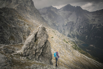 woman adventure hiker on mountain summit