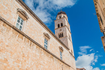 Fototapeta premium Wall of Franciscan church and monastery with tower bell in old town Dubrovnik, Croatia