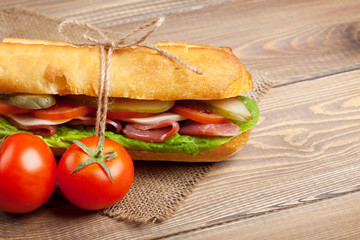 Sandwich with salad, ham, cheese and tomatoes