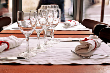 Table with napkin, glasses for wine, fork and knife
