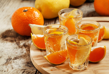 Tangerine and lemon drink soda on a wooden table, selective focu