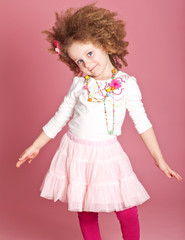 Happy curly girl in a scarf in studio 