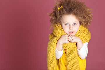 Happy curly girl in a scarf in studio 