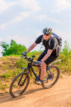 cyclist wearing a helmet on a mountain bike moves