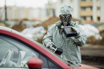 Scientist (radiation supervisor) in protective clothing and gas