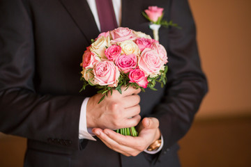 wedding bouquet in groom hand