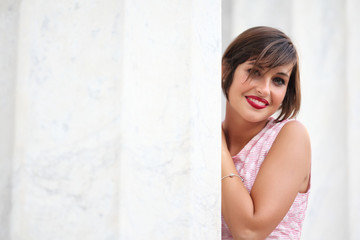Fototapeta premium Portrait of smiling girl in urban background