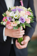 Obraz na płótnie Canvas wedding bouquet in groom hand