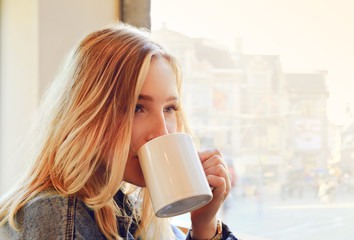 Beautiful girl drinking a cup of coffee