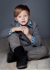 young boy in jacket  are posing in studio 