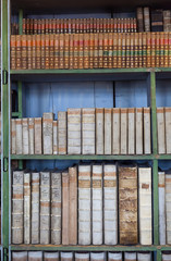 historic old books in library, wooden bookshelf