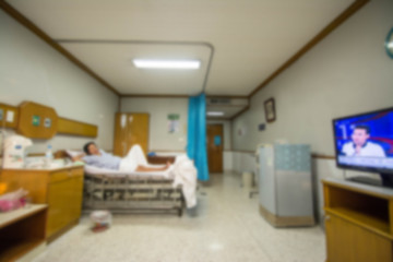 blurred image of Patient with drip in hospital for background usage.
