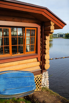 wooden house and a boat on the lake