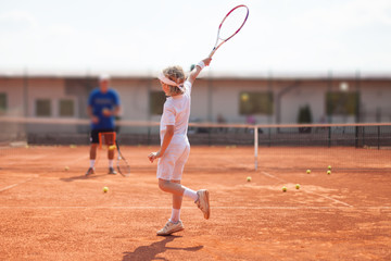 boy practicing tennis