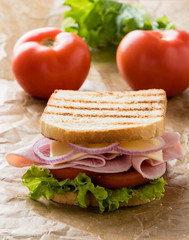 toast ham sandwich on brown paper
