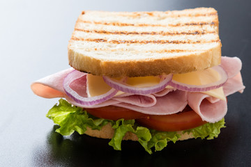 toast ham sandwich on black table