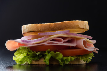 toast ham sandwich on black table