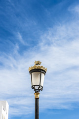 Fototapeta na wymiar Black lamppost with golden ornaments