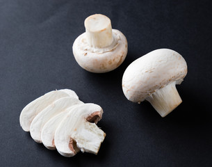 champignon mushrooms on black table