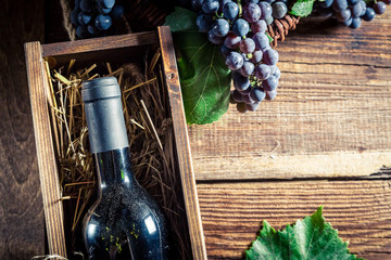 Tasty red wine in wooden box
