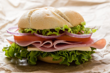 ham sandwich on brown paper