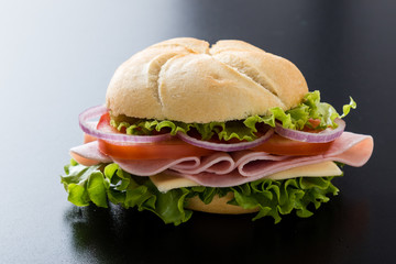 ham sandwich on black table