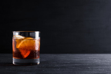 Old fashioned cocktail on the wooden background