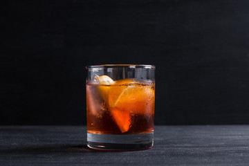 Old fashioned cocktail on the wooden background