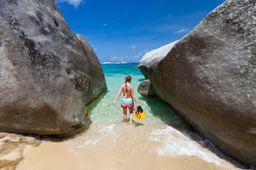 Woman with snorkeling equipment at tropical beach