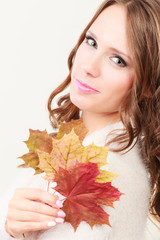 Lovely autumnal girl with maple leaves in hand