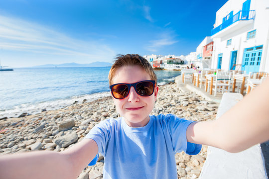 Cute teenage tourist making selfie