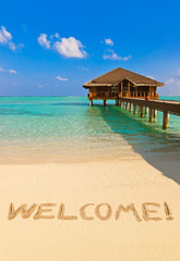 Word Welcome on beach