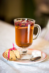 glass Cup of fruit tea with biscuits