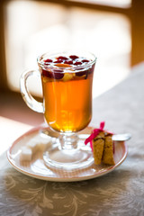 glass Cup of fruit tea with biscuits
