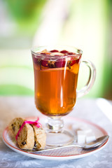 glass Cup of fruit tea with biscuits