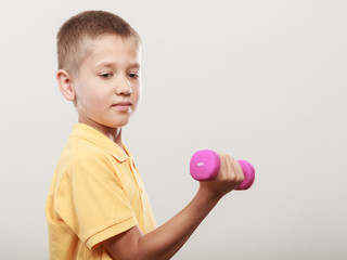 Sports boy making exercise with dumbbell.