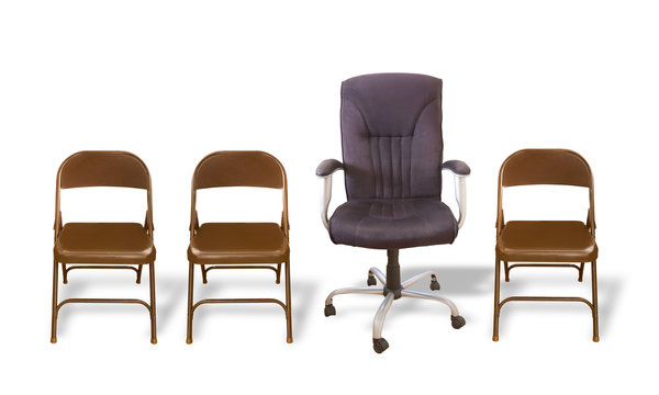 Executive's Chair - One cushioned office chair between several  plain folding chairs