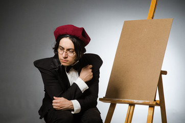 Funny artist in dark studio
