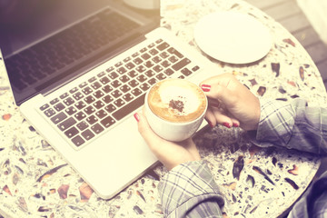 Girl with coffee mug and laptop