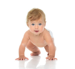 Infant child baby girl in diaper crawling happy looking at the c
