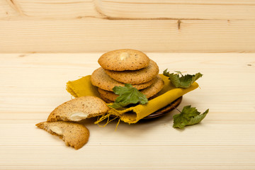 Homemade macaroons stacked on ceramic saucer close-up
