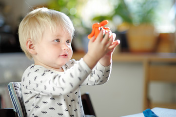 Toddler playing with play dough