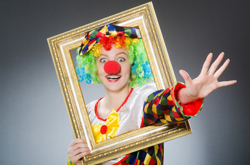 Fototapeta premium Clown with picture frame in funny concept