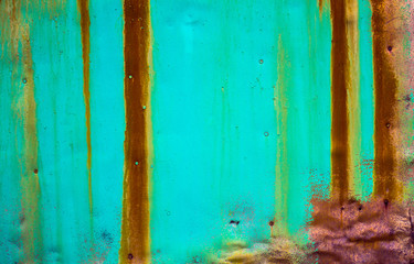 Old painted metal background.Metal surface covered with old paint with rusty streaks