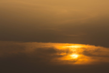 Fototapeta na wymiar golden sky with clouds cover sun