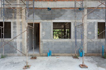 building residential construction house with scaffold steel
