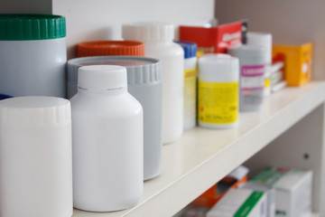Bottles of pills arranged on shelf at drugstore