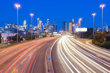 High speed traffic and light trails in highway at twilight