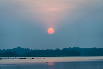 Violet sky beautiful morning rising sun near the lake