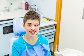 boy with braces in the chair of the dentist